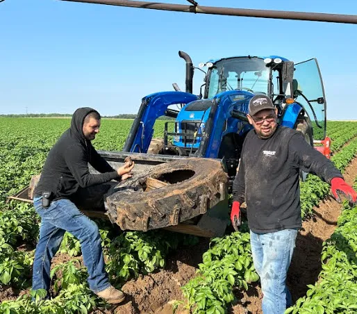 Changing the tire on a tractor in the field