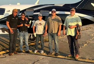 Neumiller Farm employees in front of plane