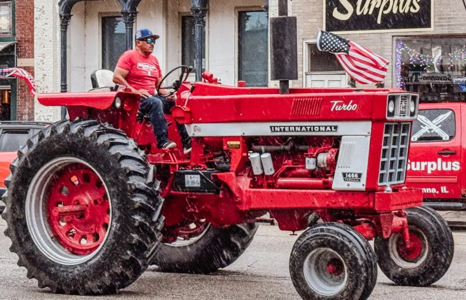 Driving an older red tractor downtown